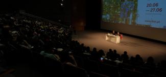 Theatre with audience and a panel