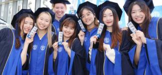 UBC student Tamano Nishida (left) with friends wearing Yonsei University’s graduation gown on the last day of class (photo: Tamano Nishida)